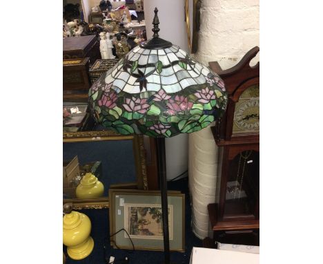 A Tiffany style standing lamp with dragonfly decoration.