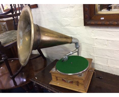 A Englis grammar phone in a golden oak case with brass horn.