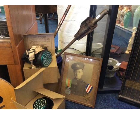 Lot to include World War II framed portrait with two medals, African walking stick, leather cased dagger and three gas masks.