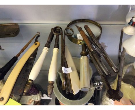 A collection of utensils including spy glass with mother of pearl handle, nut cracker, two cut throat razors etc.