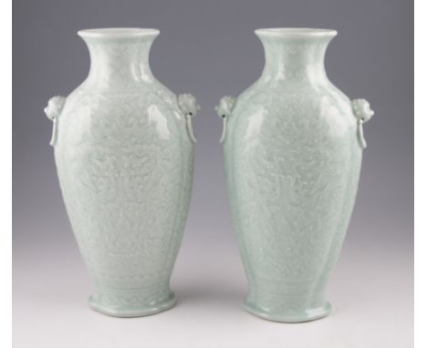 A pair of Chinese Celadon glazed vases, both of shouldered form with relief scroll and foliage decoration to bodies with two 