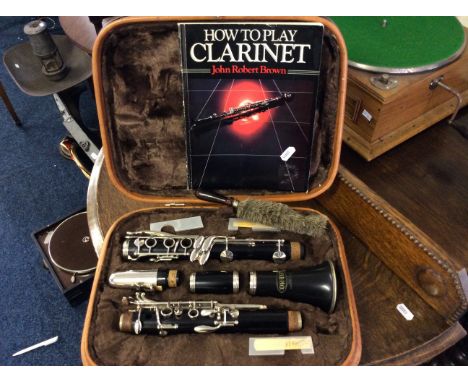 A Corton clarinet in leather case with how to learn book.