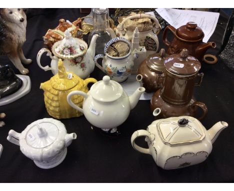 A collection of various teapots in different styles, including a lustre Carltonware teapot with legs.