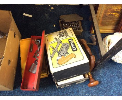 A collection of tools including Stanley combination plane and various boots and nails.
