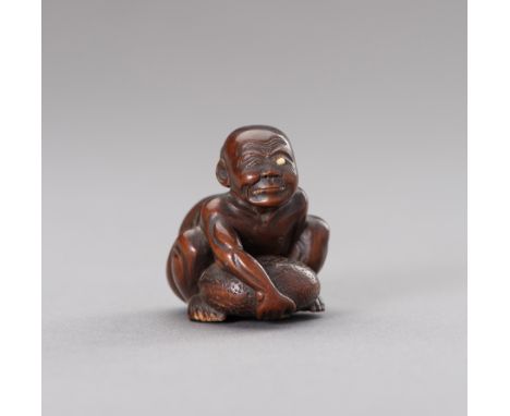 A WOOD NETSUKE OF A BLIND STONE LIFTERJapan, Meiji period (1868-1912)The wood netsuke finely carved to depict a crouching bli