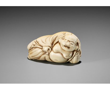 Ɏ AN IVORY NETSUKE OF A RECLINING HOTEI WITH HOSSU (FLYWHISK)Japan, 18th century, Edo period (1615-1868)Finely carved in a re