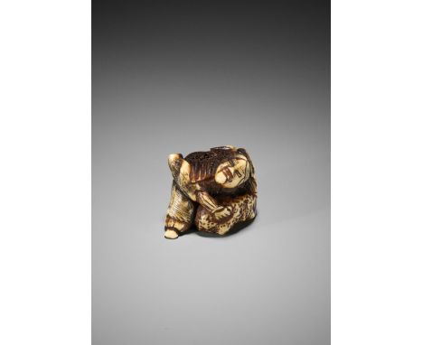 A STAG ANTLER NETSUKE OF MATANO NO GOROUnsignedJapan, Edo period (1615-1868)Carved as Matano no Goro in attempt to lift a lar