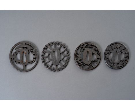 A GROUP OF FOUR IRON TSUBAJapan, Edo period (1615-1868) or earlier  The first a Kyo-sukashi tsuba of maru-gata form, executed