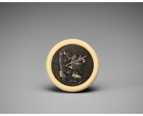 Ɏ AN IVORY AND METAL KAGAMIBUTA NETSUKE DEPICTING A KONOHA TENGU WITH A GEISHAJapan, late 19th centuryOf circular form, the i