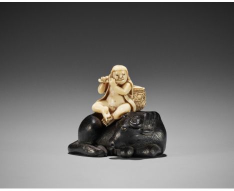 Ɏ A FINE IVORY AND EBONY NETSUKE OF AN OX-HERDER AND OXJapan, Edo/Tokyo, second half of 19th centuryFinely carved as a young 