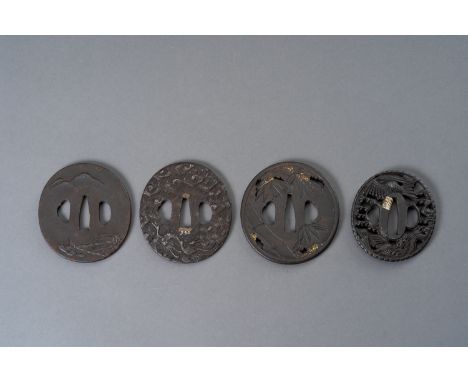 A GROUP OF FOUR IRON TSUBAJapan, Edo period (1615-1868)The first of maru-gata form, decorated in takabori with a fishing vill