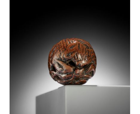 A WOOD NETSUKE OF A COILED WINGED DRAGONJapan, 18th century, Edo period (1615-1868)Of compact, spherical temari-shaped form, 