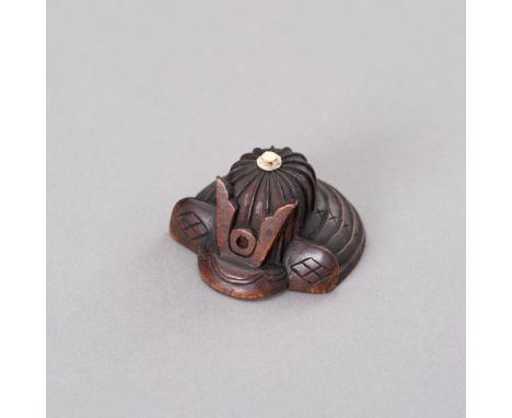 A WOOD NETSUKE OF A KABUTOJapan, Meiji period (1868-1912)The wood netsuke carved in the shape of a kabuto helmet with finely 