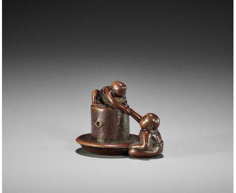 A FINE WOOD NETSUKE OF TWO BOYS AND MORTARJapan, early 19th century, Edo period (1615-1868)Finely carved as two children play