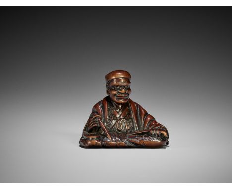 A WOOD NETSUKE OF A CALLIGRAPHERJapan, early 19th century, Edo period (1615-1868)The shokoda (calligrapher) modelled seated, 