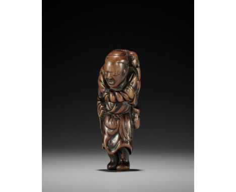 AN EARLY WOOD NETSUKE OF A SARUMAWASHIUnsignedJapan, 18th century, Edo period (1615-1868)Expressively and boldly carved as a 