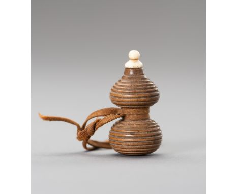 A HYOTAN SHAPE WOOD NETSUKEJapan, 19th centuryThe netsuke of hyotan (double gourd) form, carved from wood, wrapped by a braid