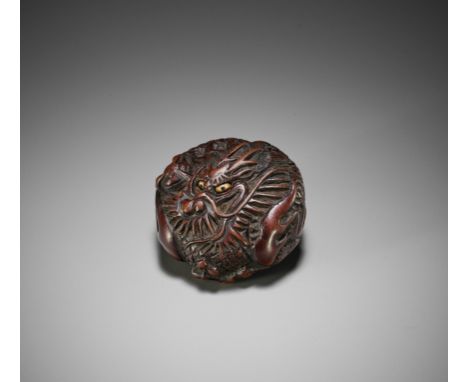 A WOOD NETSUKE OF A COILED DRAGONJapan, late 18th to early 19th century, Edo period (1615-1868)The thick manju netsuke boldly