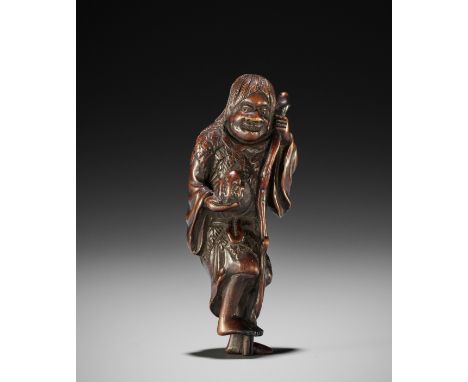 A TALL WOOD NETSUKE OF GAMA SENNINJapan, c. 1800, Edo period (1615-1868)Boldly carved standing on one foot, the other slightl