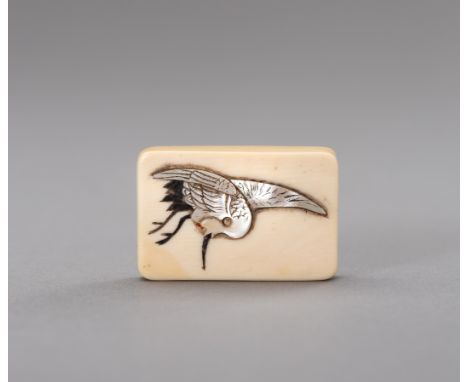 Ɏ AN IVORY NETSUKE DEPICTING A CRANEJapan, Meiji period (1868-1912)The ivory netsuke of rectangular form, decorated with aoga