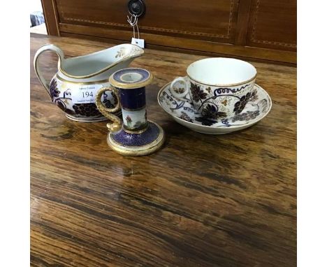 An English china teacup, saucer and milk jug, c.1830, with grape and vine leaf blue and white  gilded decoration and a Barr F