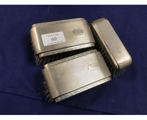 A set of three silver backed engine turned hairbrushes (larges: 11cm x 6cm)