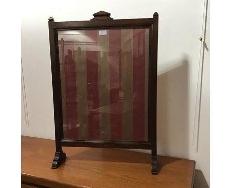An early 20thc mahogany glazed firescreen with striped silk panel, on shaped supports (h.81cm x 55cm x 15cm)