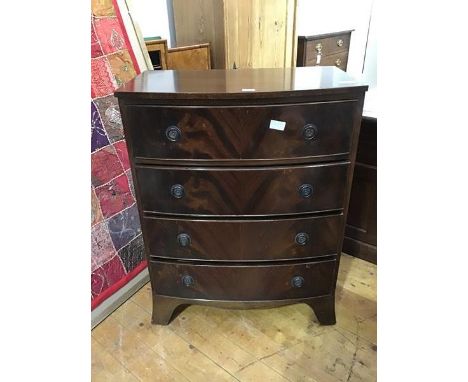 A reproduction bow front chest of drawers, the plain top above four long drawers, with shaped apron, on splay bracket feet (9