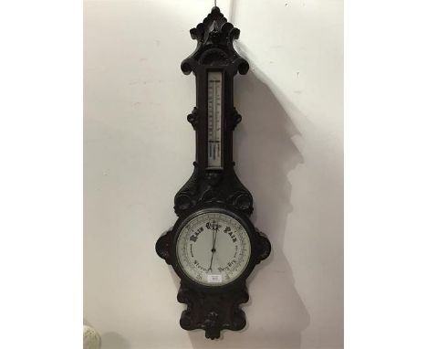 A 19thc/20thc. carved oak banjo style barometer, the carved top above a cased thermometer, with allover carving (h.88cm x 32c