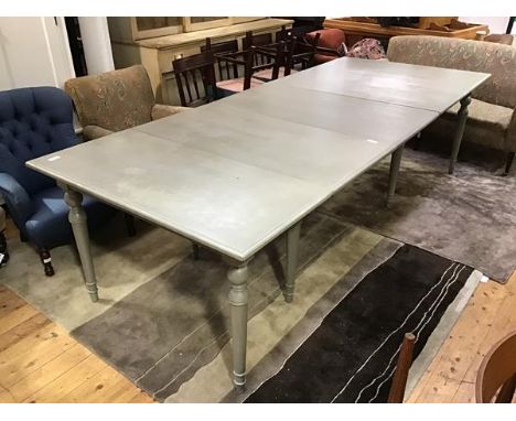 An Oka extending dining table in the Victorian style with painted finish in Lamp Room Gray, the rectangular top with plain mo