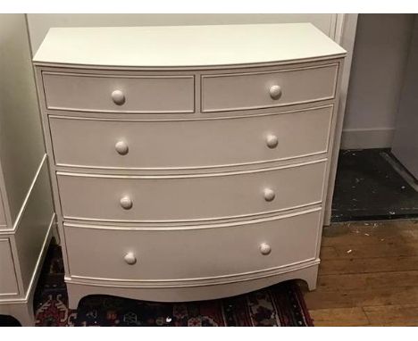 A Georgian style white painted bow front chest of drawers, the top with moulded edge above two short and three long graduated