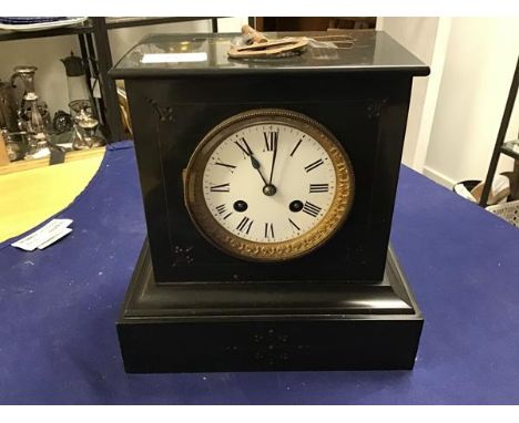 A 19thc slate mantle clock, the rectangular top above a circular white enamelled dial with roman numerals, on rectangular bas