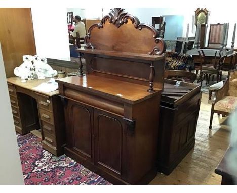 A Victorian chiffonier, the carved back with open shelf raised on turned supports, the rectangular top a bove fitted single f