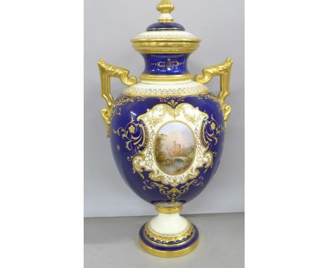 An early 20th Century Coalport porcelain vase and cover, cobalt blue and gilt with hand painted panel, Lismore Castle, signed