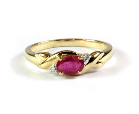 A 9ct yellow gold ring set with an opal cut ruby and diamonds, (N.5).