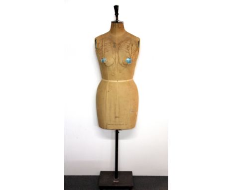 An early 20th century Kennett & Lindsell mannequin on an iron base, H. 155cm.
