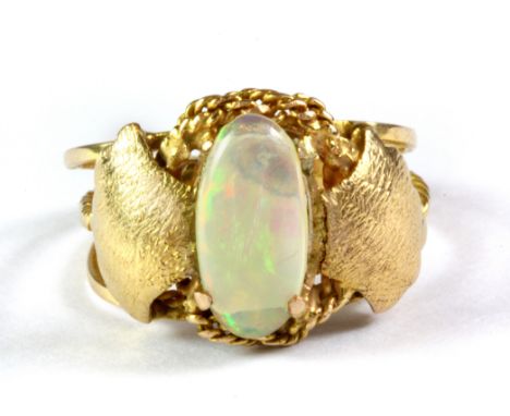 A yellow metal (tested high carat gold with foreign marks) set with a cabochon cut opal, (P).
