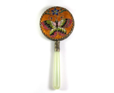 A small Chinese enamelled hand mirror with jade handle, L. 14.5cm.
