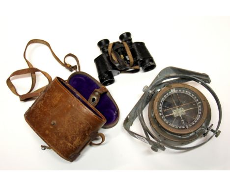 An old aircraft compass and a pair of binoculars.