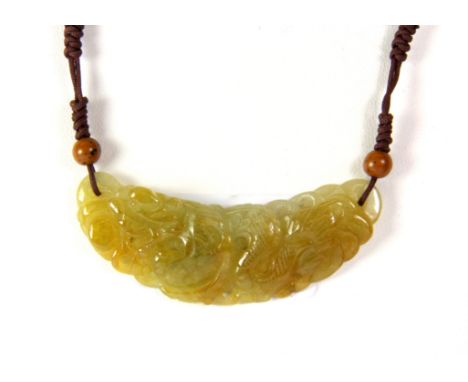 A 19th century Chinese carved mixed colour jadeite jade hair ornament of a dragon remounted as a pendant, W. 6cm.