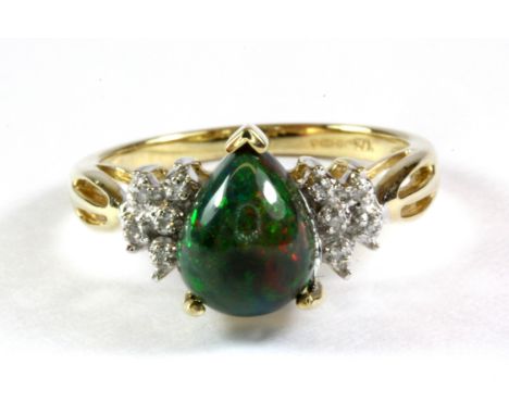 A 9ct yellow gold ring set with a cabochon cut pear shaped black opal and diamonds, (M.5).