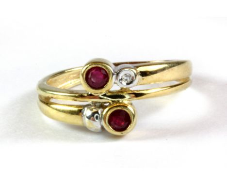 A yellow metal (tested minimum 9ct yellow gold) crossover ring set with rubies and a diamond, (K.5).