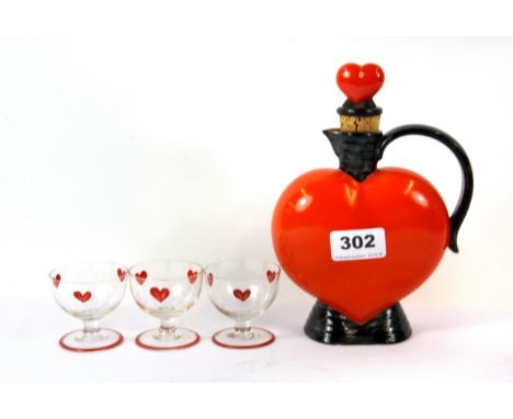 A vintage heart shaped ceramic decanter, H. 20cm, with three glasses.