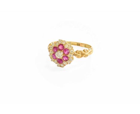 A Ruby and Diamond Cluster Ring, the central old cut diamond within a border of round cut rubies, to a further border of old 