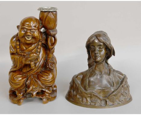 An Art Nouveau Style Bronze Bust of a Lady, 20cm high, together with a root wood figural carved candlestick in the form of Bu