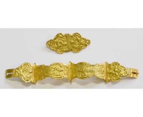 A Fancy Bangle, with embossed decoration, inner measurements 6.5cm by 6cm; and A Matching Brooch, measurements 6.2cm by 2.8cm