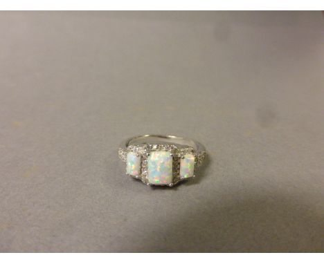 A silver, cz and three stone opal ring