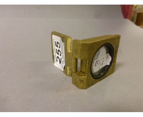 A vintage pocket magnifier stamped INCR