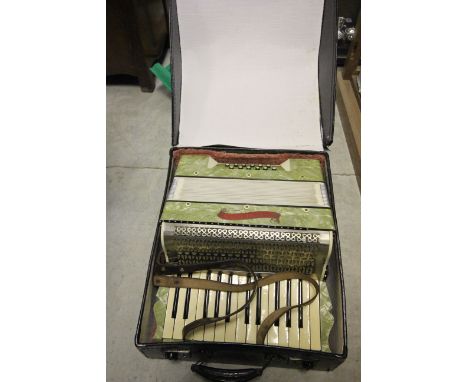 A German Tonella piano accordion with green marble effect finish in original case