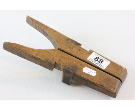 A vintage wooden folding boot jack